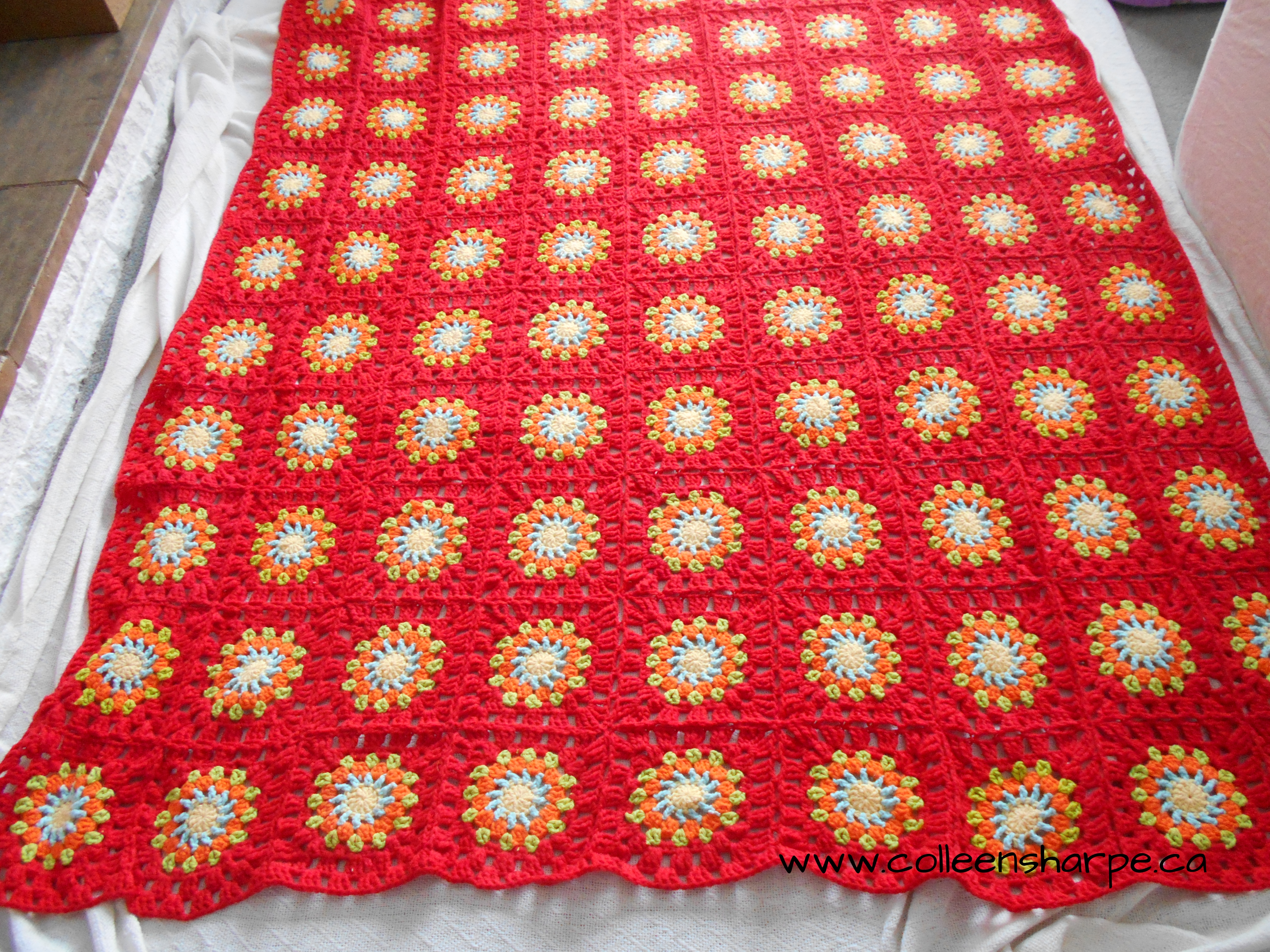 red multicoloured crochet granny circle blanket